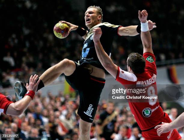 Markus Andreas Jakobsson of Iceland blocks the ball against Lars Kaufmann of Germany during the Men's Handball World Championship Group I game...