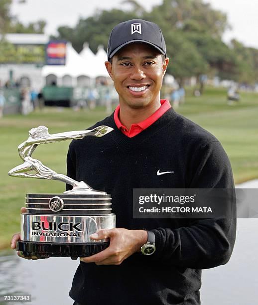 La Jolla, UNITED STATES: Golfer Tiger Woods poses with his trophy after winning the Buick Invitational PGA Golf Tournament Final Round in La Jolla,...