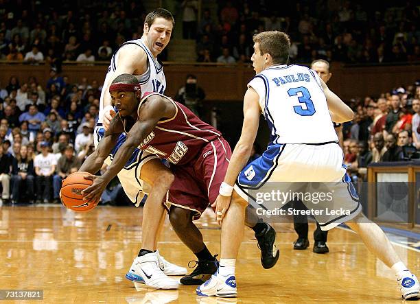 Tyrese Rice of the Boston College Eagles goes to the basket as Josh McRoberts and teammate Greg Paulus of the Duke Blue Devils tries to block him...