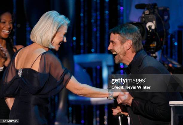 Actress Helen Mirren accepts her Oustanding Female Actor in a Motion Picture award for "The Queen" from actor Jeremy Irons onstage at the 13th Annual...