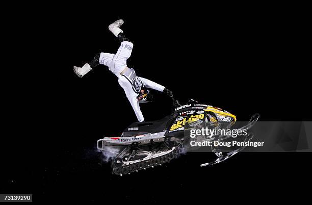 Heath Frisby of Caldwell, Idaho, does an aerial maneuver en route to winning the bronze medal in the inaugural Snowmobile Freestyle at the ESPN...