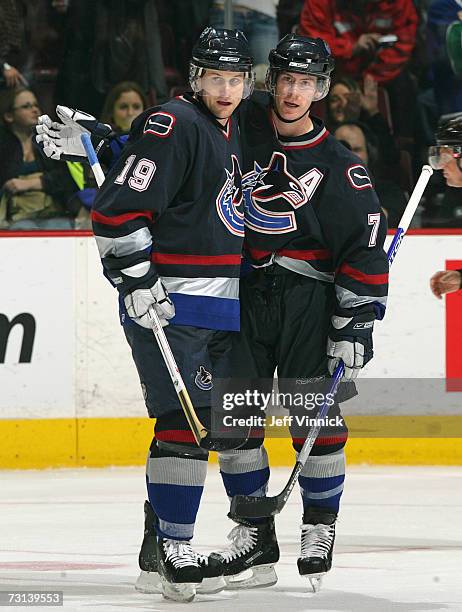 Brendan Morrison of the Vancouver Canucks is congratulated by teammate Markus Naslund after scoring against the San Jose Sharks at General Motors...