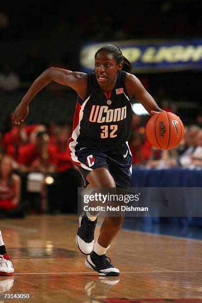 Kalana Greene of the University of Connecticut Huskies drives against the St. John's University Red Storm at Madison Square Garden on January 21,...