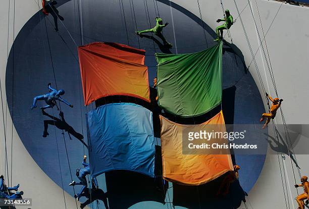 Members of the "GROUNDED Aerial Dance Theater" hang from ropes and dance on a poster promoting Vista, a new version of Microsoft Windows, on the side...