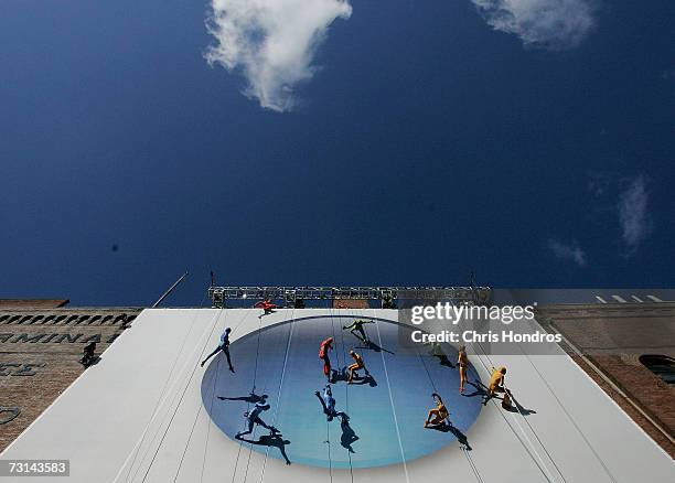 Members of the "GROUNDED Aerial Dance Theater" hang from ropes and dance on a poster promoting Vista, a new version of Microsoft Windows, on the side...