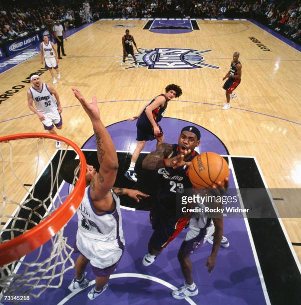 LeBron James of the Cleveland Cavaliers shoots against Maurice Taylor of the Sacramento Kings at Arco Arena on January 9, 2007 in Sacramento,...
