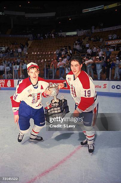 Canadian professional ice hockey players Ray Whitney and Pat Falloon of the Western Hockey League's Spokane Chiefs pose with the trophy on the ice...