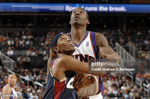 Amare Stoudemire of the Phoenix Suns and Daniel Gibson of the Cleveland Cavaliers attempt to rebound the ball during the NBA game on January 11 at...