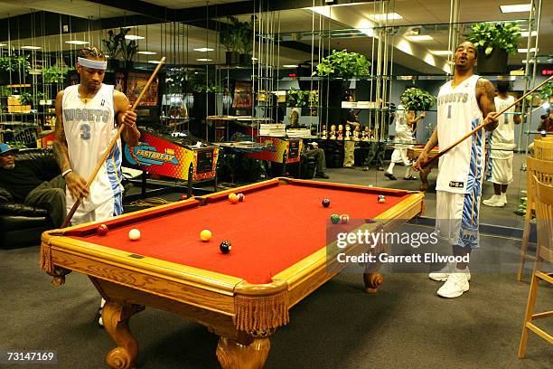 Allen Iverson and J.R. Smith of the Denver Nuggets play pool before the game against the Charlotte Bobcats on January 29, 2007 at the Pepsi Center in...