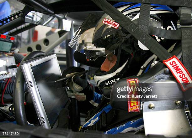 Ryan Newman, driver of the Alltel Dodge, works on a laptop computer in his car during NASCAR testing at Las Vegas Motor Speedway January 29, 2007 in...