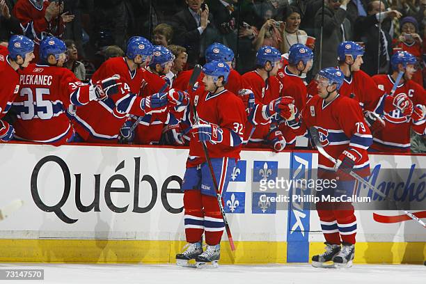 Mark Streit of the Montreal Canadiens celebrates a goal against the Ottawa Senators with teammates on the bench during the second period at the Bell...
