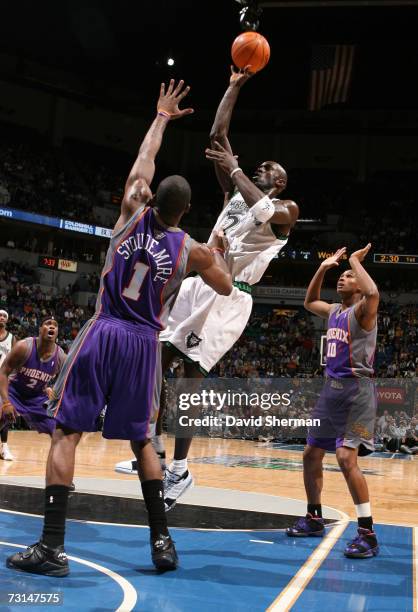 Kevin Garnett of the Minnesota Timberwolves goes up against Amare Stoudemire of the Phoenix Suns on January 29, 2007 at the Target Center in...