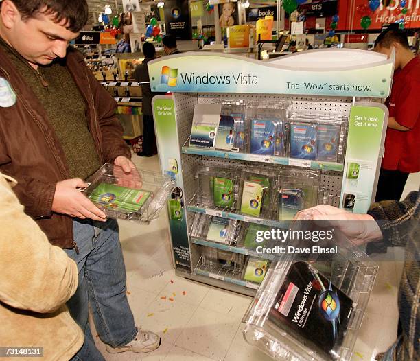 Customers look over copies of Vista during a software release party for the operating system at a Comp USA store, January 30 in Houston, Texas. More...