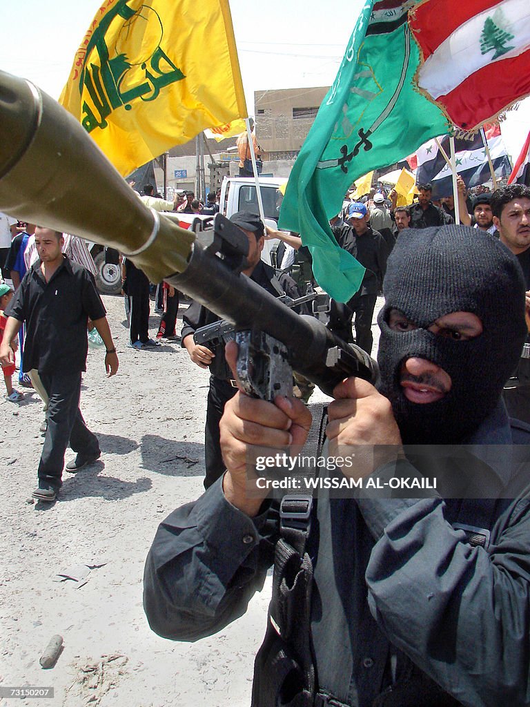 Armed members of radical Shiite cleric M...
