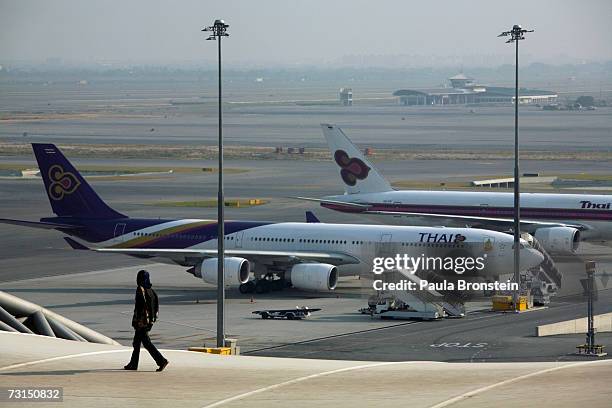 Worker walks along the roof at the new Bangkok Suvarnabhumi international airport January 30, 2007 in Bangkok, Thailand. The new $4 billion airport...