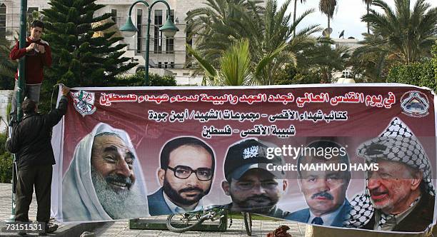 Palestinian hang a large banner of late Palestinian leaders from left to right:- the spiritual leader of Hamas Sheikh Ahmed Yassin assassinated by...