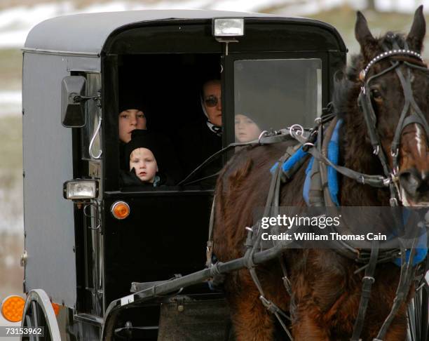 Members of the Amish community pass the site of the old schoolhouse in which five Amish girls were murdered January 30, 2007 in Nickel Mines,...