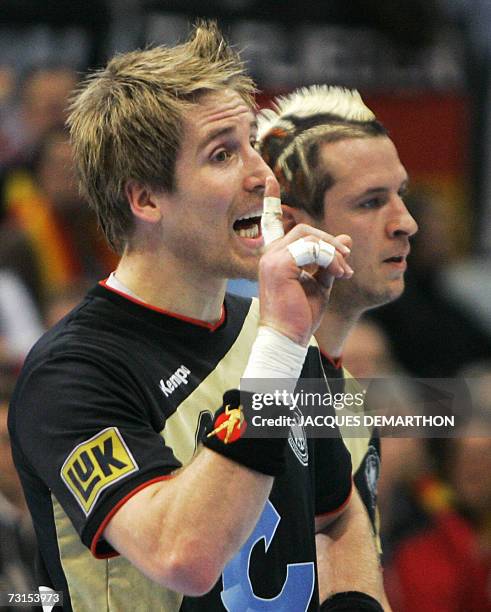 Germany's Oliver Roggisch and Pascal Hens react during their Germany vs Spain quarter-final match of the men's 2007 Handball World Championship at...