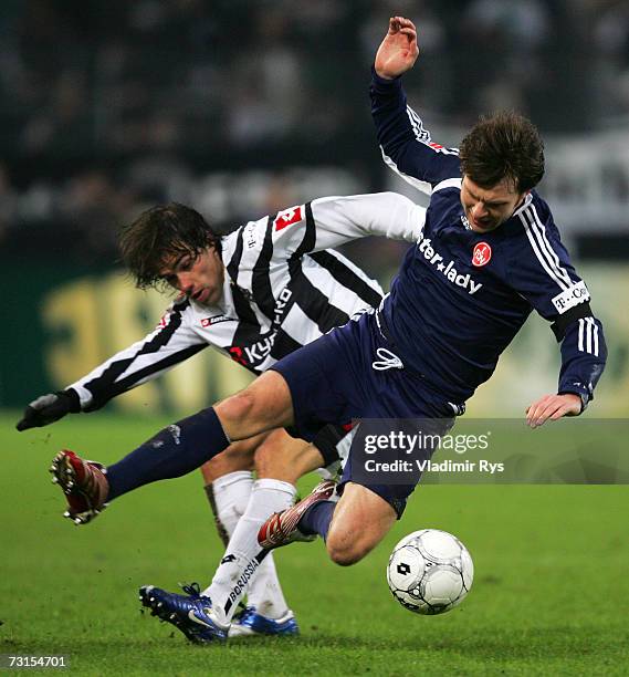 Federico Insua of Gladbach and Ivan Saenko of Nuremberg battle for the ball during the Bundesliga match between Borussia Monchengladbach and 1.FC...