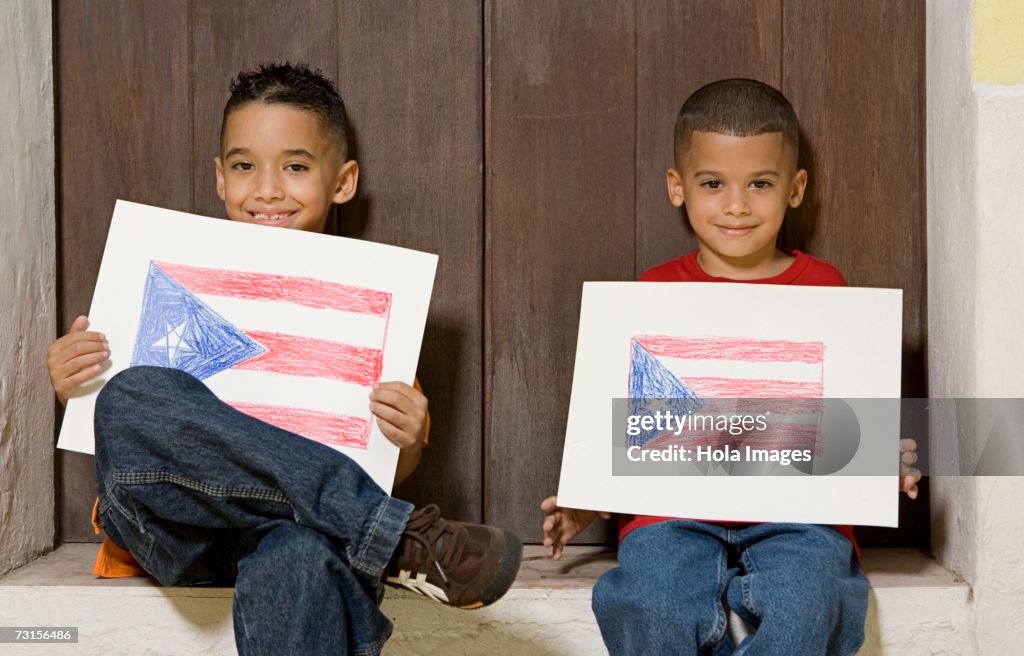 Two boys holding drawing of the Puerto Rican flag