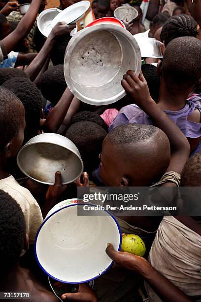 Refugee children queue to receive porridge on December 5, 2005 in Dubie, Katanga Province in Congo, Democratic Republic of the Congo. Thousands of...
