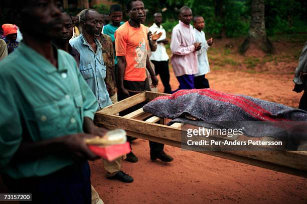 The body of a diseased child is to a nearby cemetery from a makeshift camp on December 6, 2005 in Dubie, Katanga Province in Congo, Democratic...