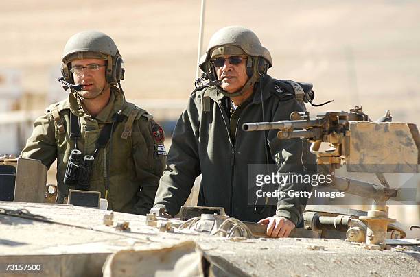 In this photo provided by the Israeli Defense Forces outgoing IDF Chief-of-Staff Dan Halutz rides in a tank during a ground forces assault exercise...