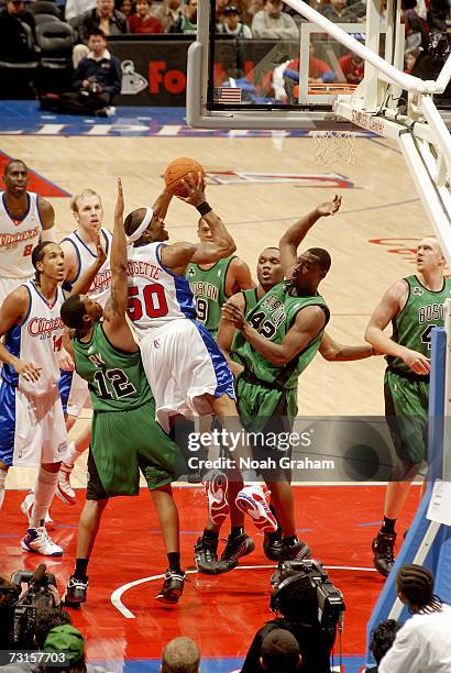 Corey Maggette of the Los Angeles Clippers takes the ball to the basket against Tony Allen and Allan Ray of the Boston Celtics during the game at...