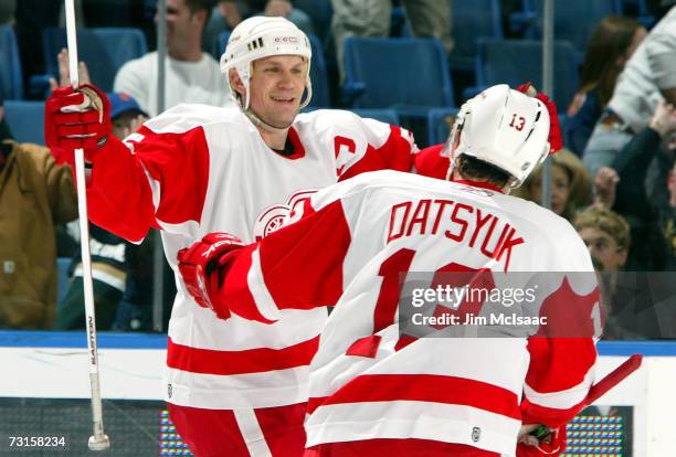 Nicklas Lidstrom of the Detroit Red Wings celebrates with Pavel Datsyuk after assisting on teammate Henrik Zetterberg's overtime goal against the New...