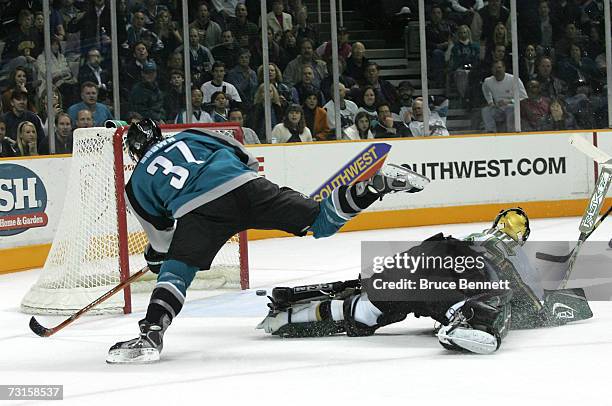 Curtis Brown of the San Jose Sharks dekes Goaltender Marty Turco of the Dallas Stars out of the net but shoots wide on January 30, 2007 at the HP...