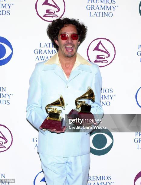 Musician Fito Paez poses with his awards for ''Best Male Rock Vocal'' and ''Best Rock Song'' at the First Annual Latin Grammy Awards September 13,...