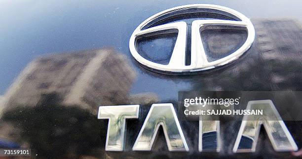 The Tata logo shines on the boot of a car reflecting high-rise buildings of south Mumbai's business district, 31 January 2007. India's Tata Steel...