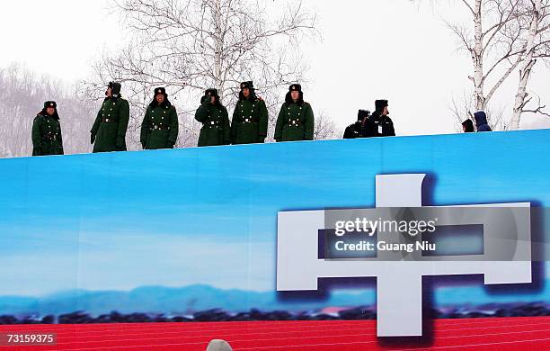 Chinese policemen watch over the women's freestyle skiing of the 6th Asian Winter Games at Jilin Beida Lake Skiing Site on January 31, 2007 on the...