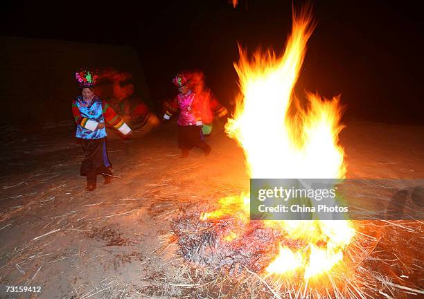 Guests dance at the bride's home during a Tu ethnic minority group wedding ceremony on January 29, 2007 in Huzhu County of Qinghai Province,...