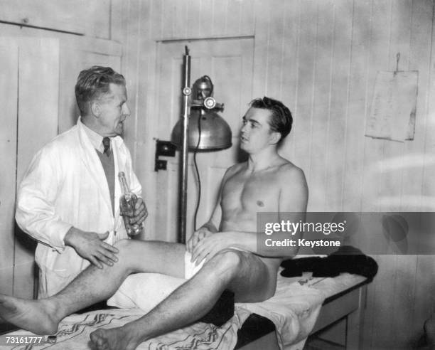 Brentford FC assistant trainer Cartmell massaging Austrian footballer Ernst Happel during a visit to the club to prepare for an international match...