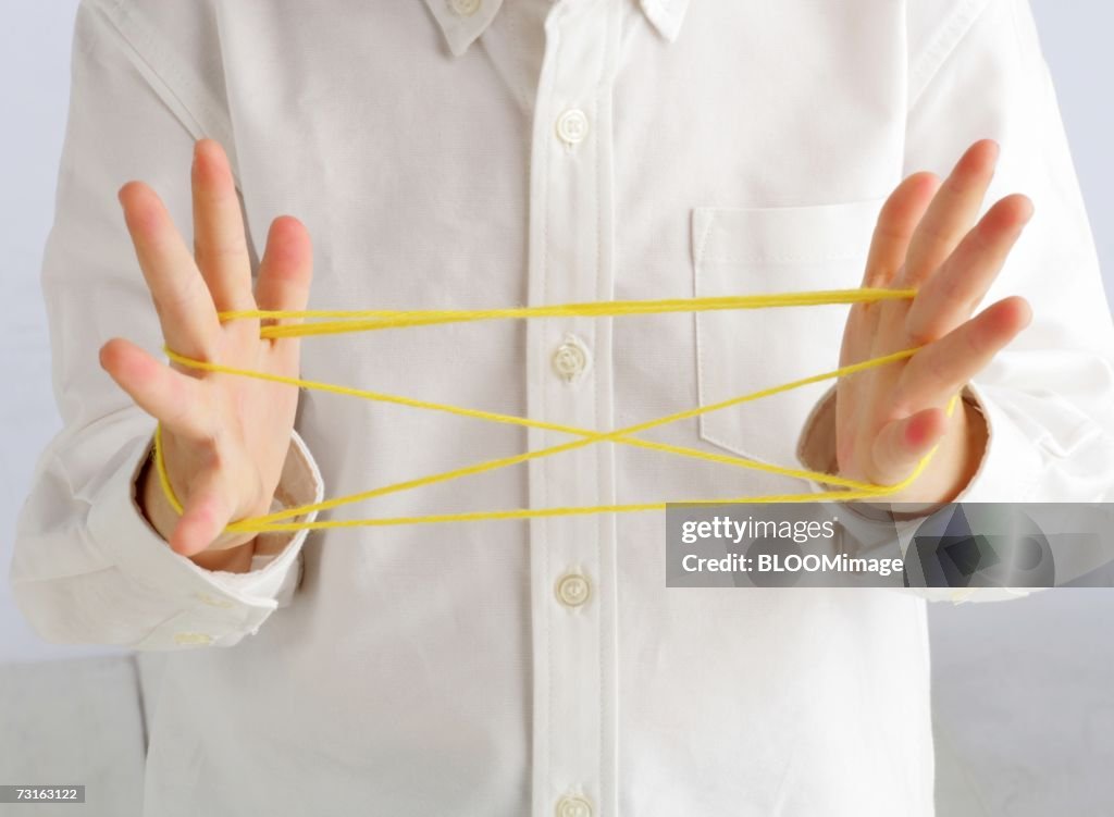 Asian child playing cat's cradle