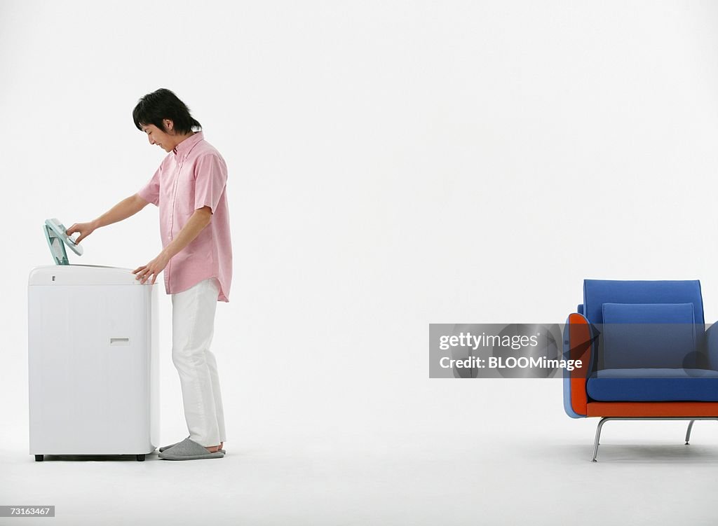 Man looking into washing machine