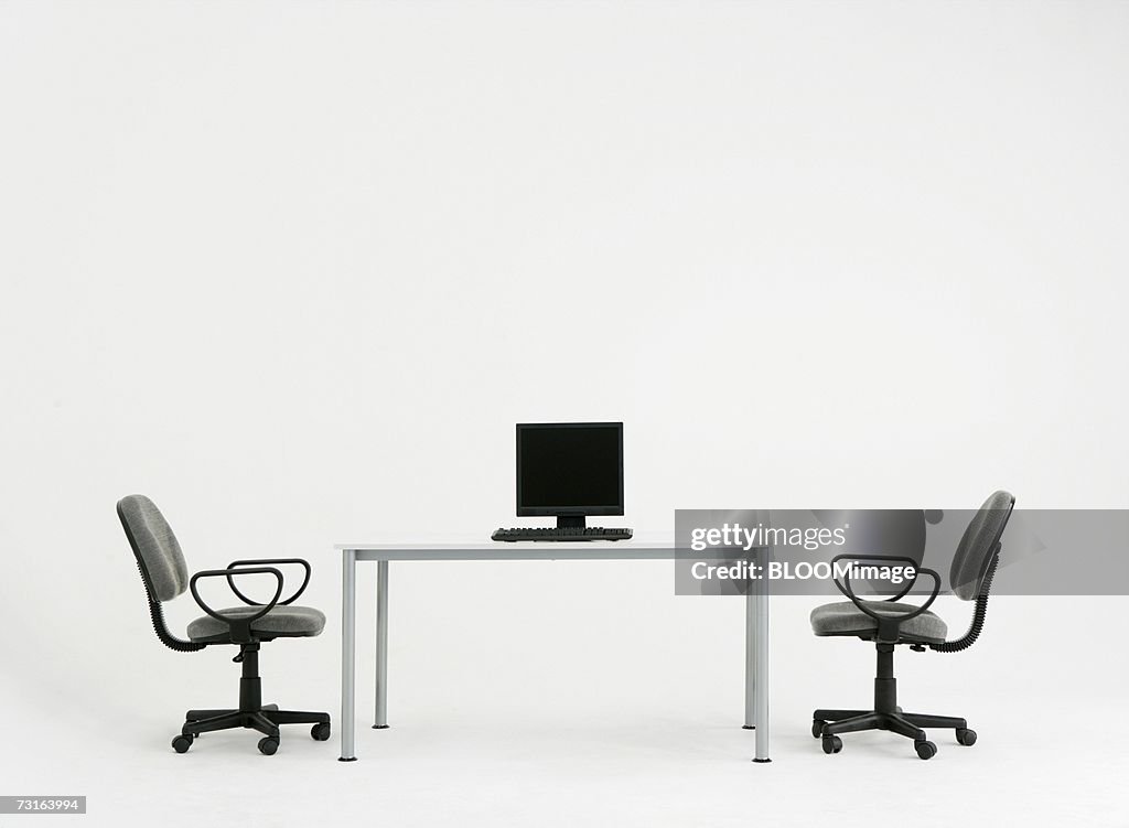 Computer on desk and chairs