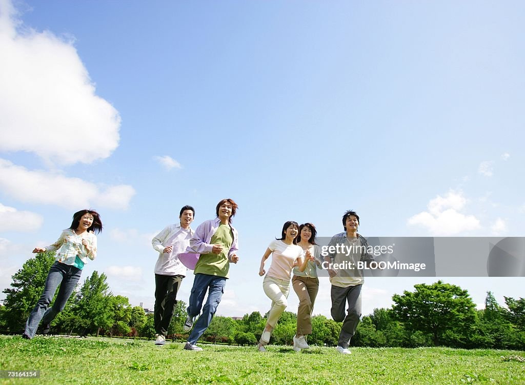 Asian people running on field