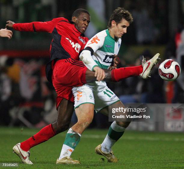 Juan of Leverkusen and Miroslav Klose of Bremen battle for the ball during the Bundesliga match between Bayer Leverkusen and Werder Bremen at the...