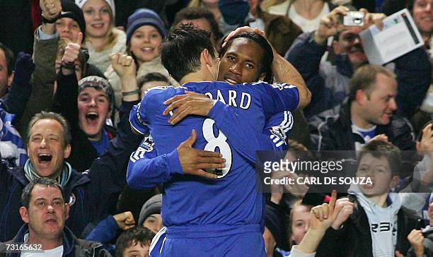 London, UNITED KINGDOM: Chelsea's Didier Drogba of Ivory Coast is congratulated by teammate and Captain, Frank Lampard after Drogba's goal against...