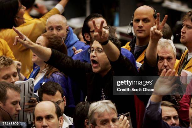 Traders signal offers in the Eurodollar options pit at the Chicago Mercantile Exchange following the announcement from the Federal Open Market...