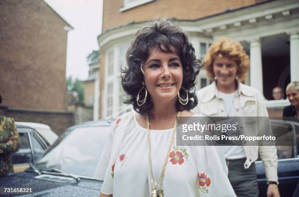 English American actress Elizabeth Taylor pictured leaving a building after visiting her newborn grandson in London on 29th July 1971.
