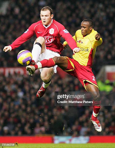 Wayne Rooney of Manchester United clashes with Alhassan Bangura of Watford during the Barclays Premiership match between Manchester United and...