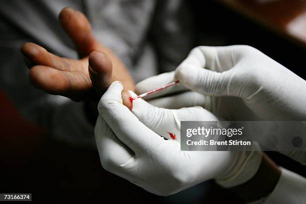 Young man undergoes an AIDS test which is HIV positive December 2006 in Nairobi, Kenya. He is having the test at Kenwa centre for HIV+ women, made...