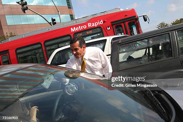 Mayoral candidate Antonio Villaraigosa, who campaigned on traffic improvements, greets commuters stuck in traffic, May 16, 2005 in Westwood, Los...