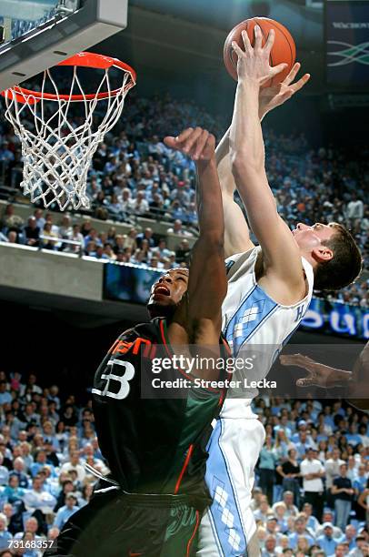 Jack McClinton of the Miami Hurricanes jumps for a loose ball with Tyler Hansbrough of the University of North Carolina Tar Heels at the Dean E....