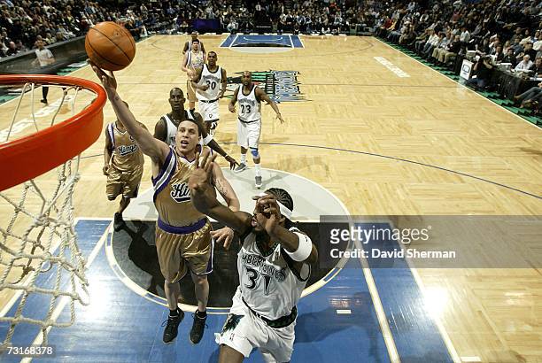 Mike Bibby of the Sacramento Kings goes to the basket against Ricky Davis of the Minnesota Timberwolves on January 31, 2007 at the Target Center in...