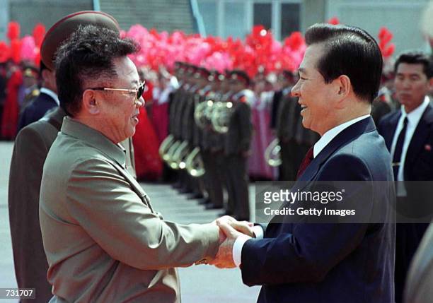 North Korean leader Kim Jong Il, left, and South Korean President Kim Dae-jung, right, shake hands as Kim Dae-jung arrives June 13, 2000 at the Sunan...