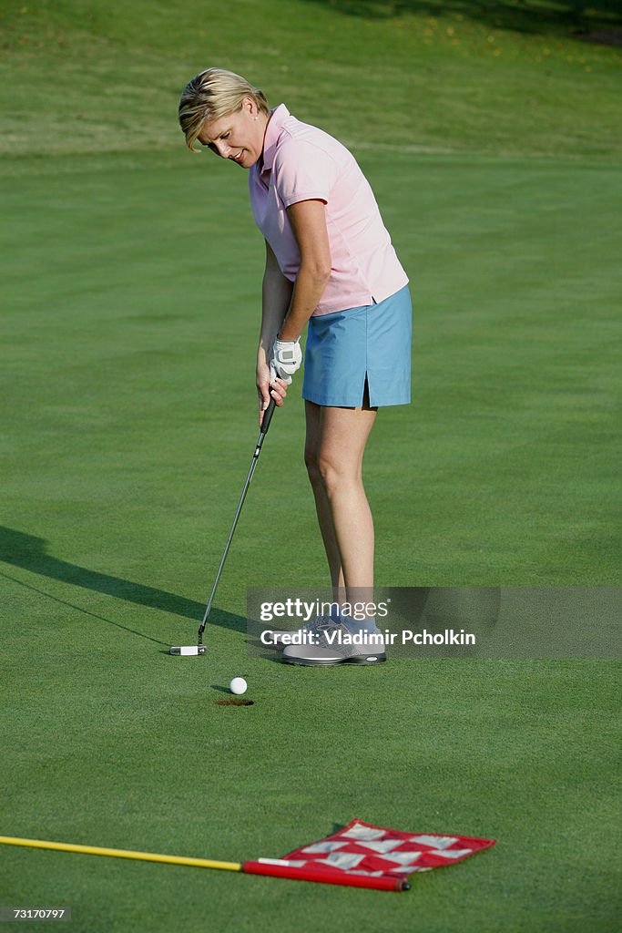 Mature woman playing golf